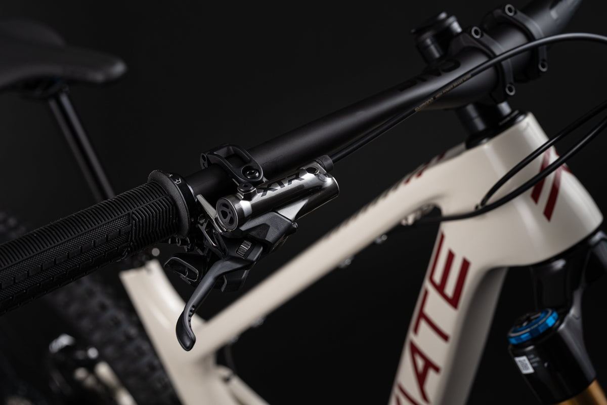 Close-up of a bicycle handlebar with brake lever on a dark background